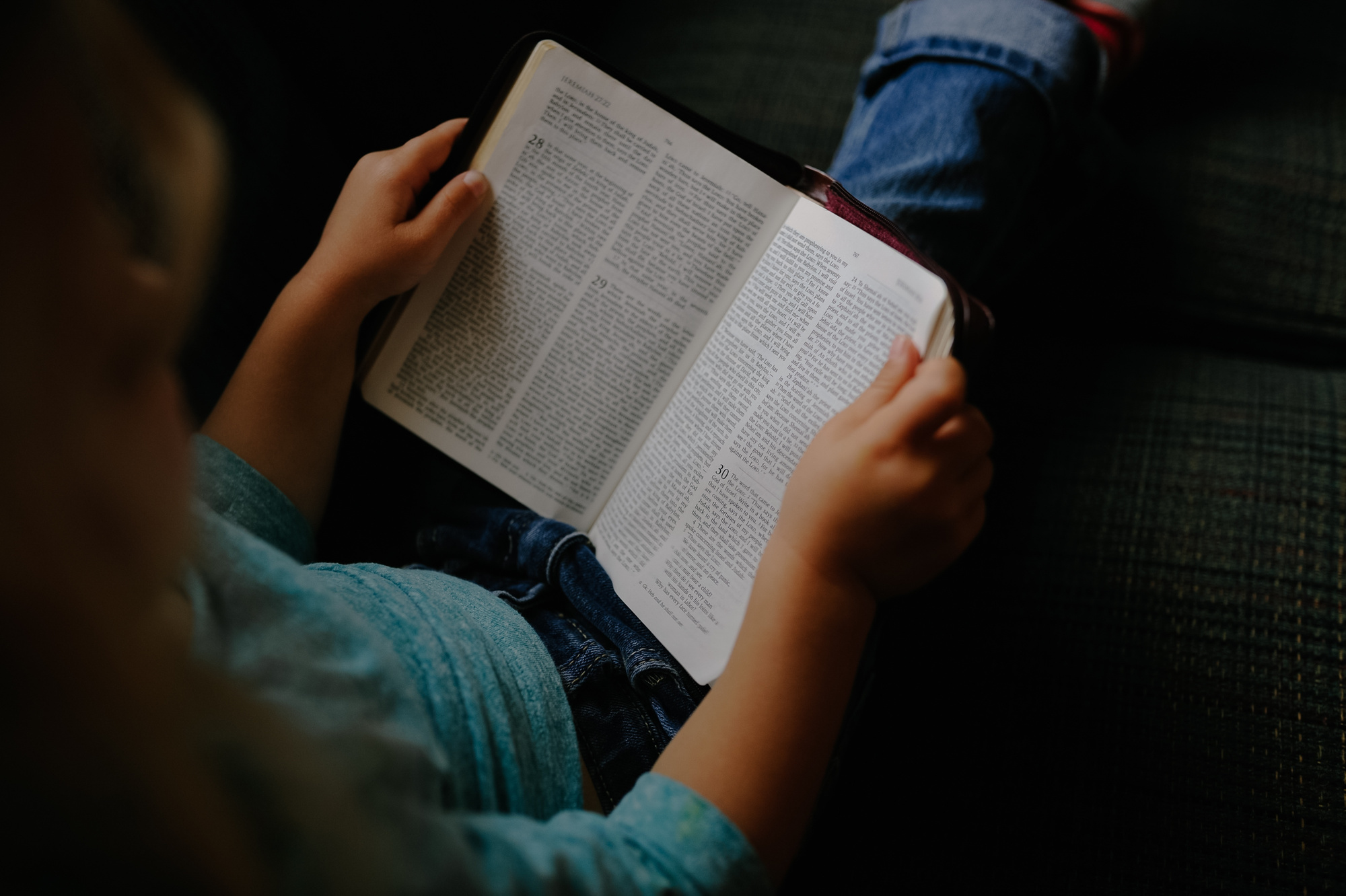 Young Kid Reading a Book on the Couch